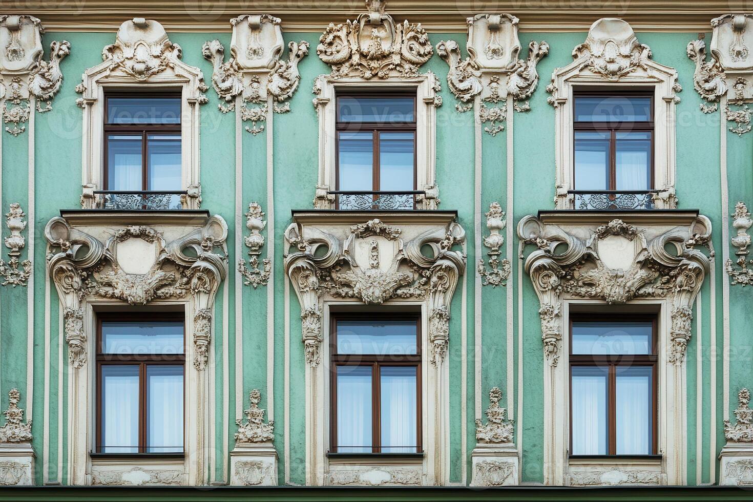Ornate facade with six windows and intricate decorative elements. photo