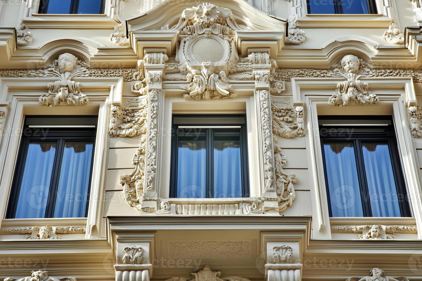 Ornate facade with three windows and intricate carvings. photo