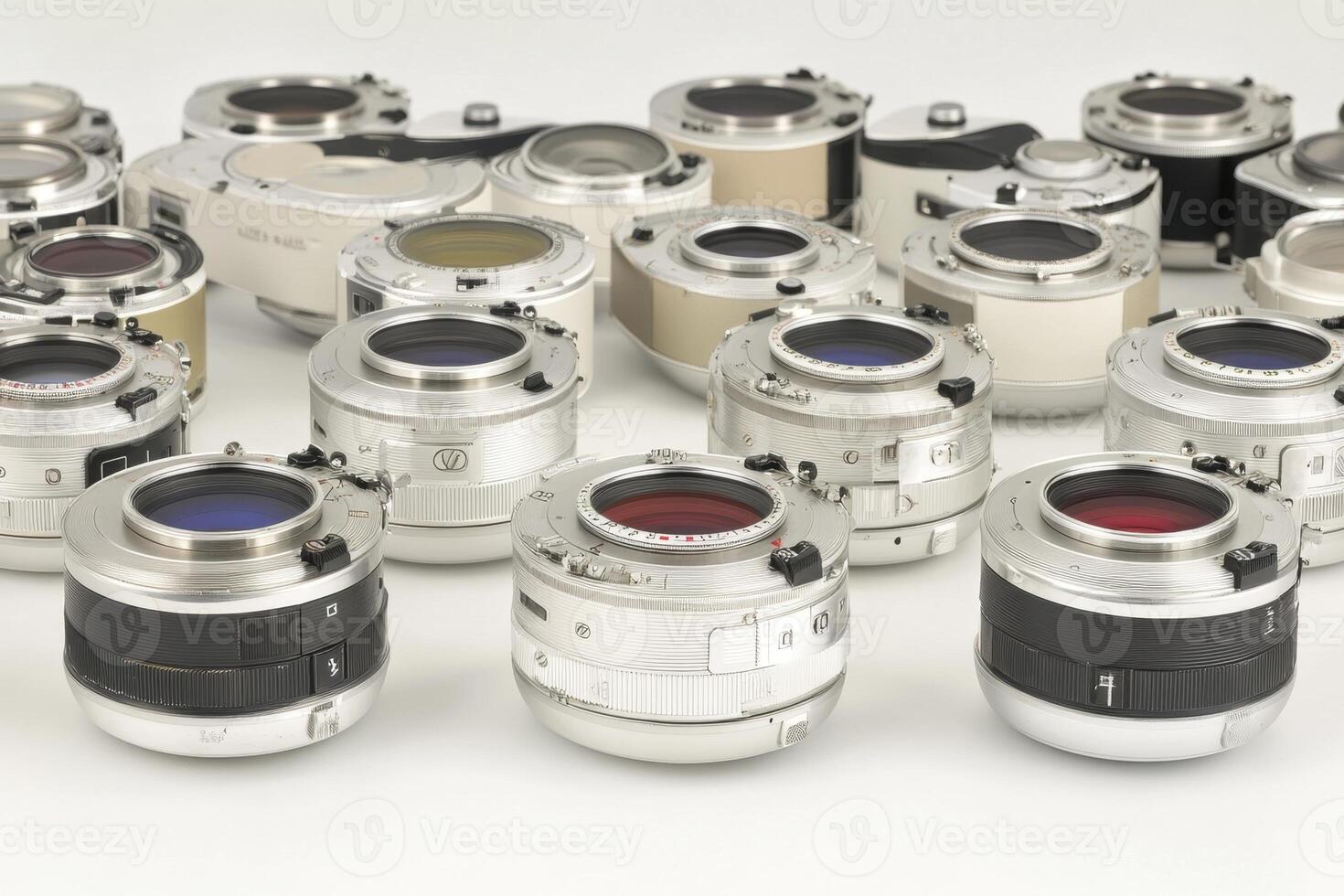 A collection of various camera lenses arranged on a white surface. photo