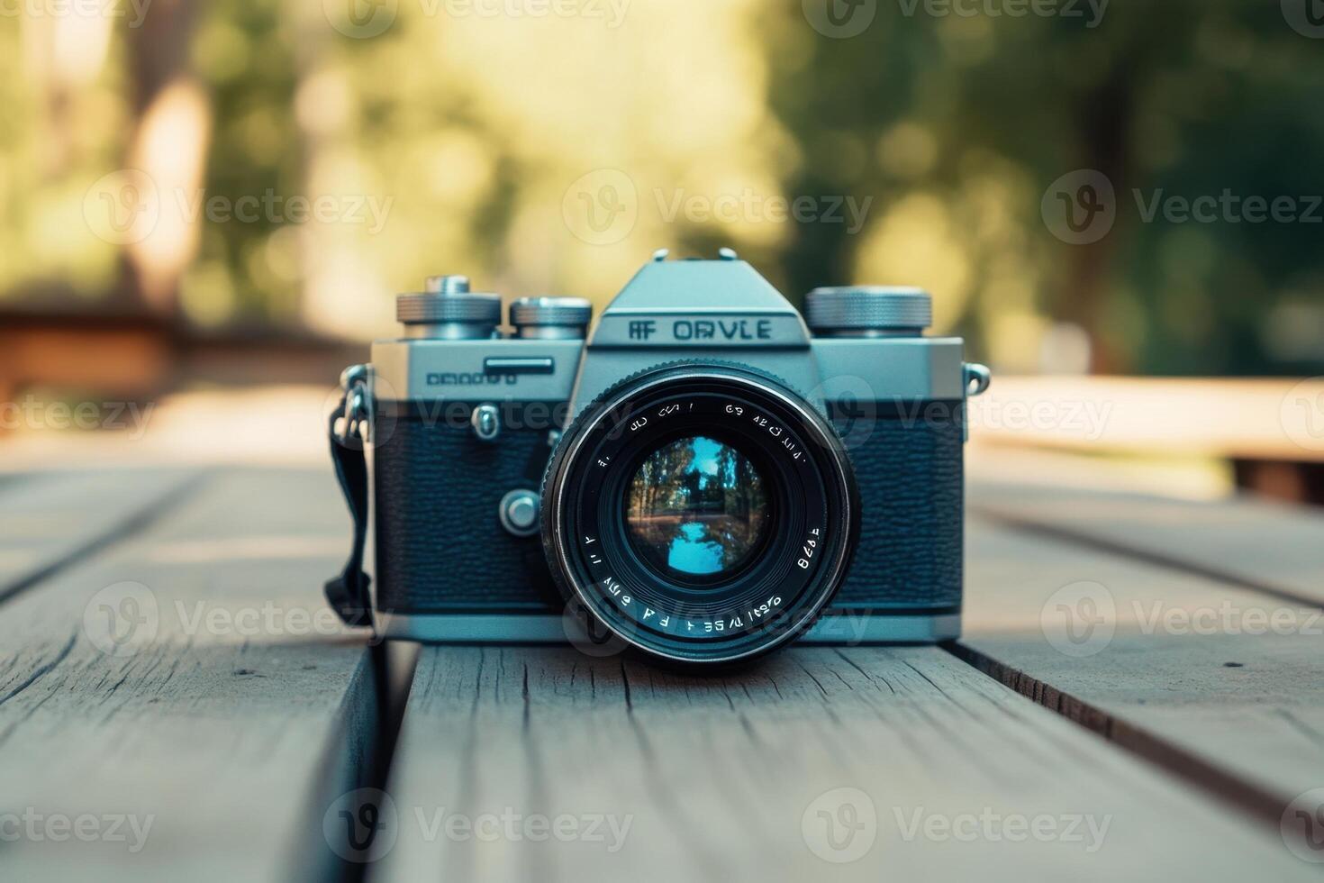 Vintage SLR camera on wooden surface. photo