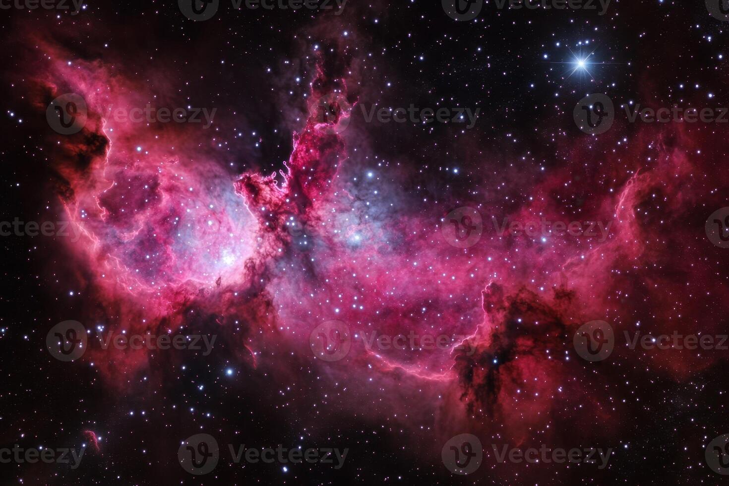 A nebula in space, with red and pink colors, and a scattered field of stars. photo