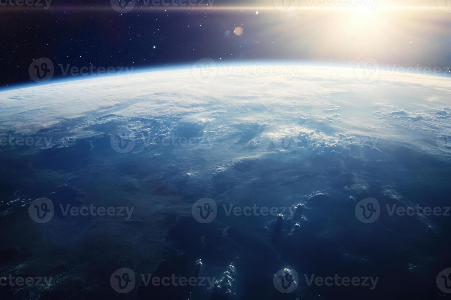 A stunning view of Earth from space, showing the blue oceans, white clouds, and a bright sun shining in the distance. photo