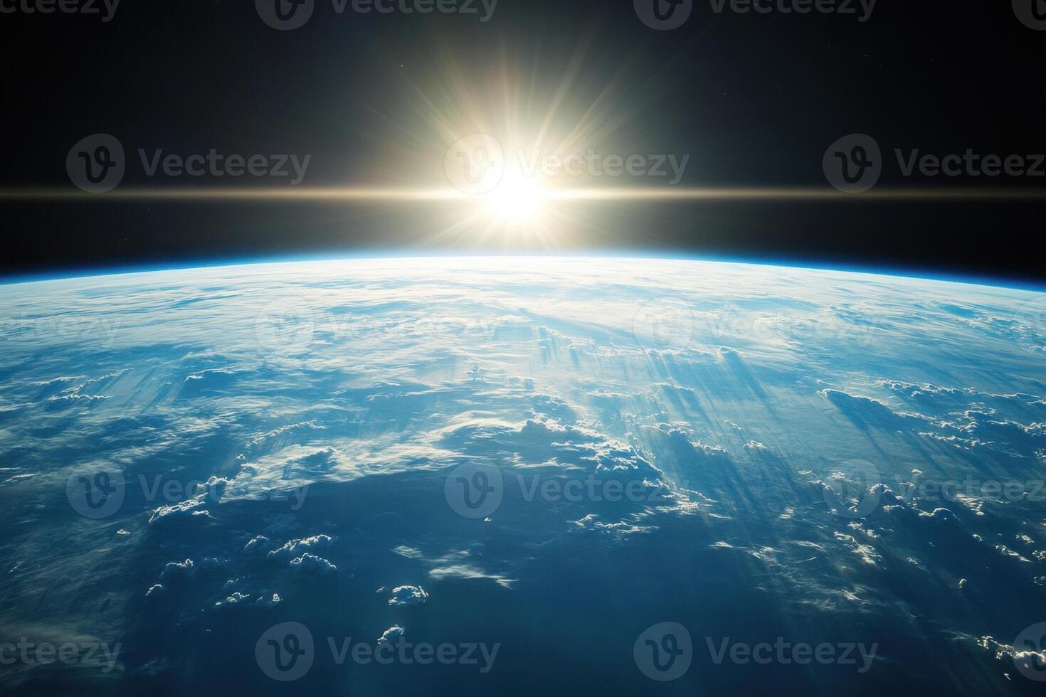 Sunrise over Earth from space, showing the planet's atmosphere, clouds, and the sun's rays. photo