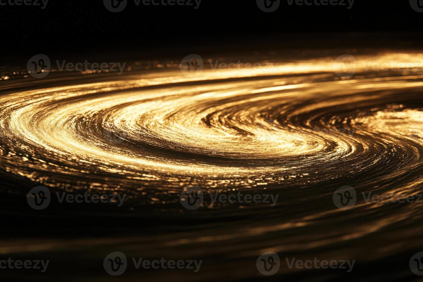 Abstract swirling golden light on black background. photo