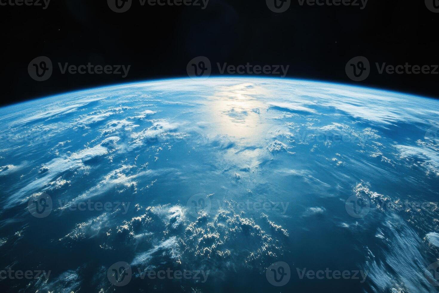 Earth from space, showing clouds, atmosphere, and a blue ocean. photo