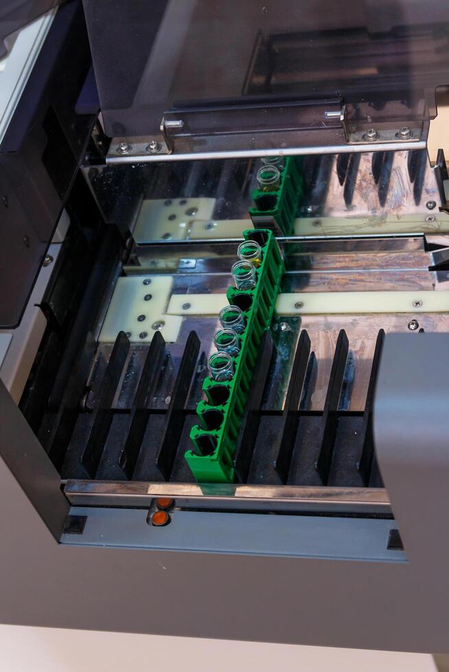 Robotic clinical lab equipment. Modern automative tube analyzing. photo