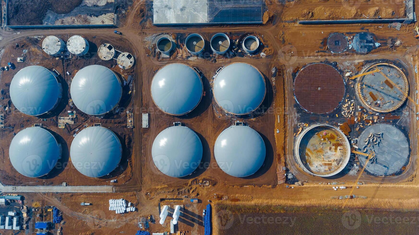 Big round storages field. Oil metal huge tanks aerial shot. photo