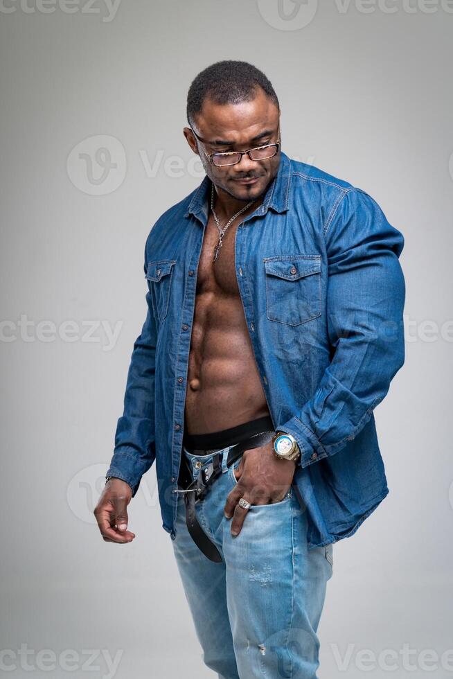 Stylish muscular man posing. Sexy male model standing in studio. photo
