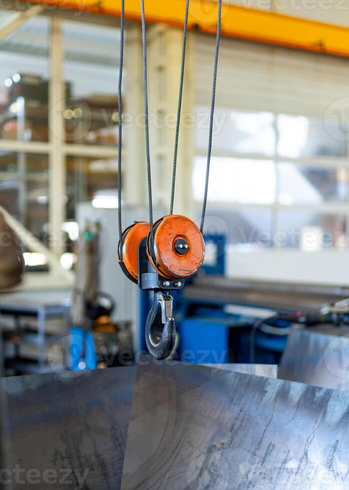 Indoor factory construction lifting. Metal factory hook crane. photo