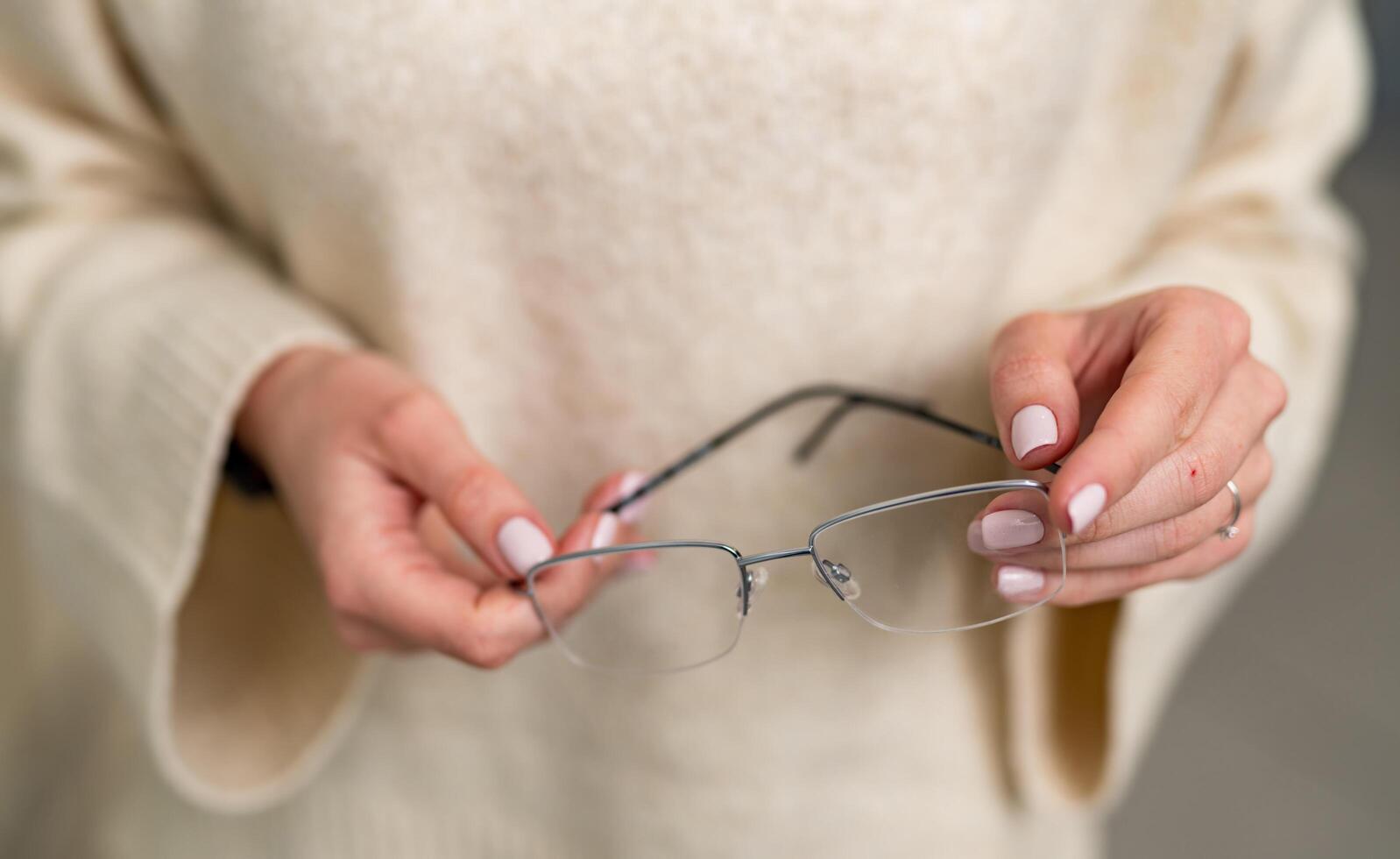 Eyeglasses in hands holding. Woman holding in optical spectacles. photo