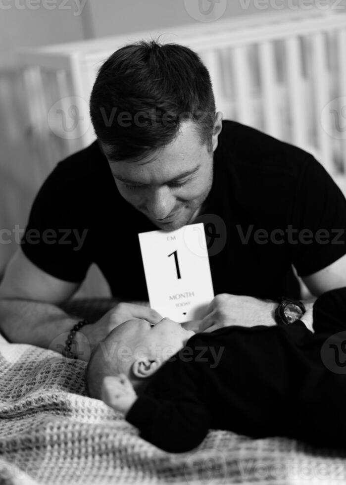Adorable dad with child son. Handsome father with newborn baby. photo
