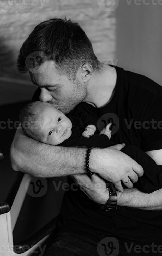 Handsome father with newborn baby. Adorable dad with child son. photo