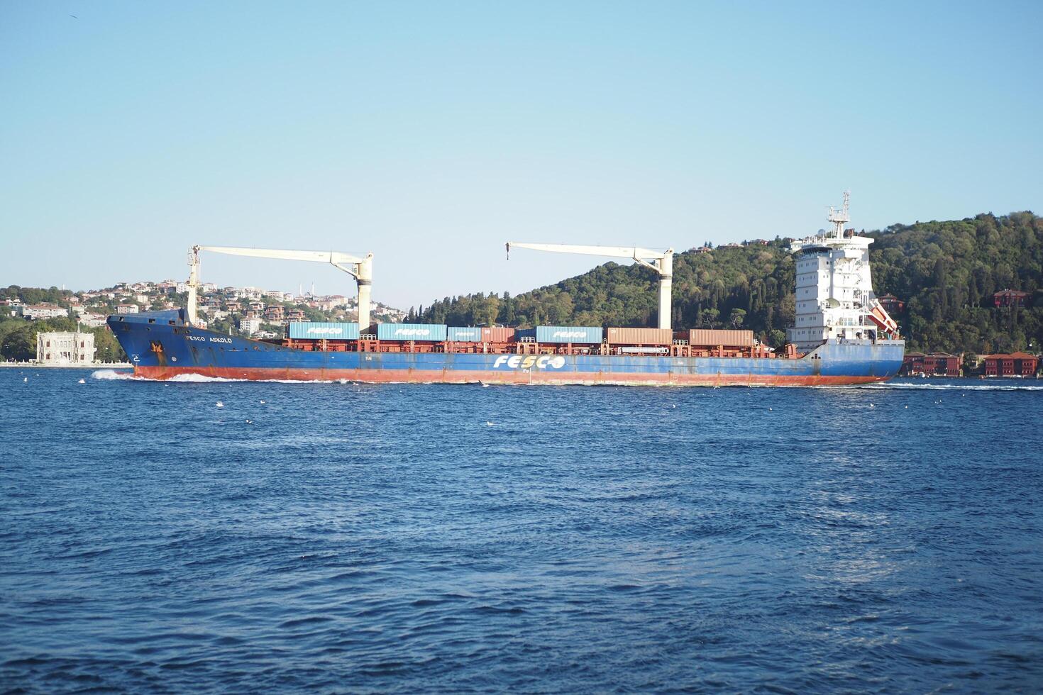 turkey istanbul 23 july 2024, A cargo ship is skillfully navigating through the tranquil and calm waters of the harbor photo