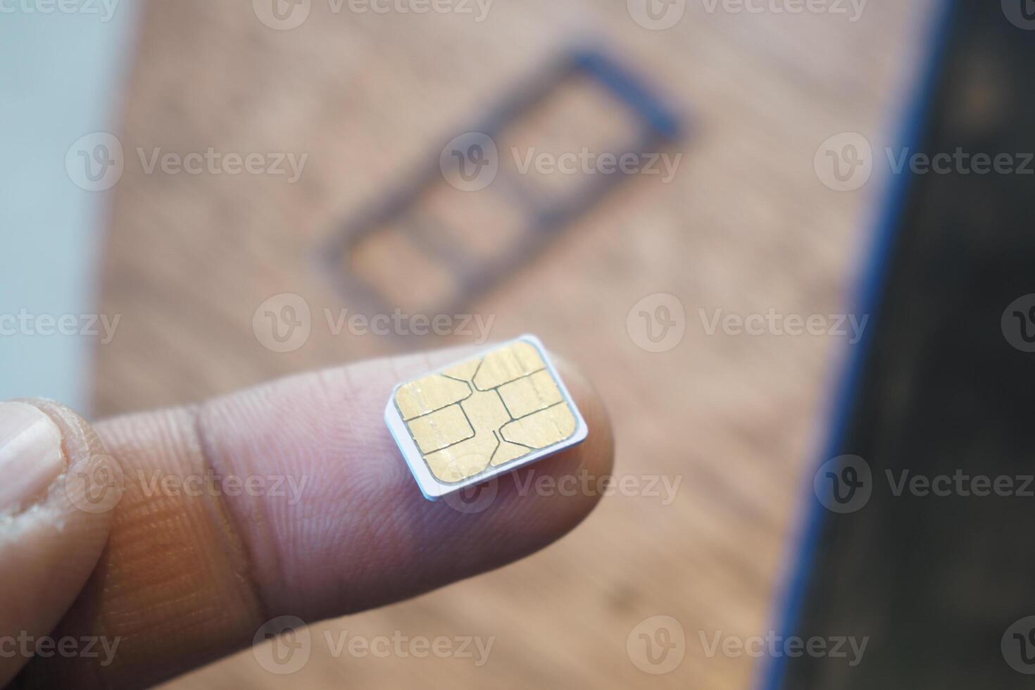A sim card for a smart phone on finger photo