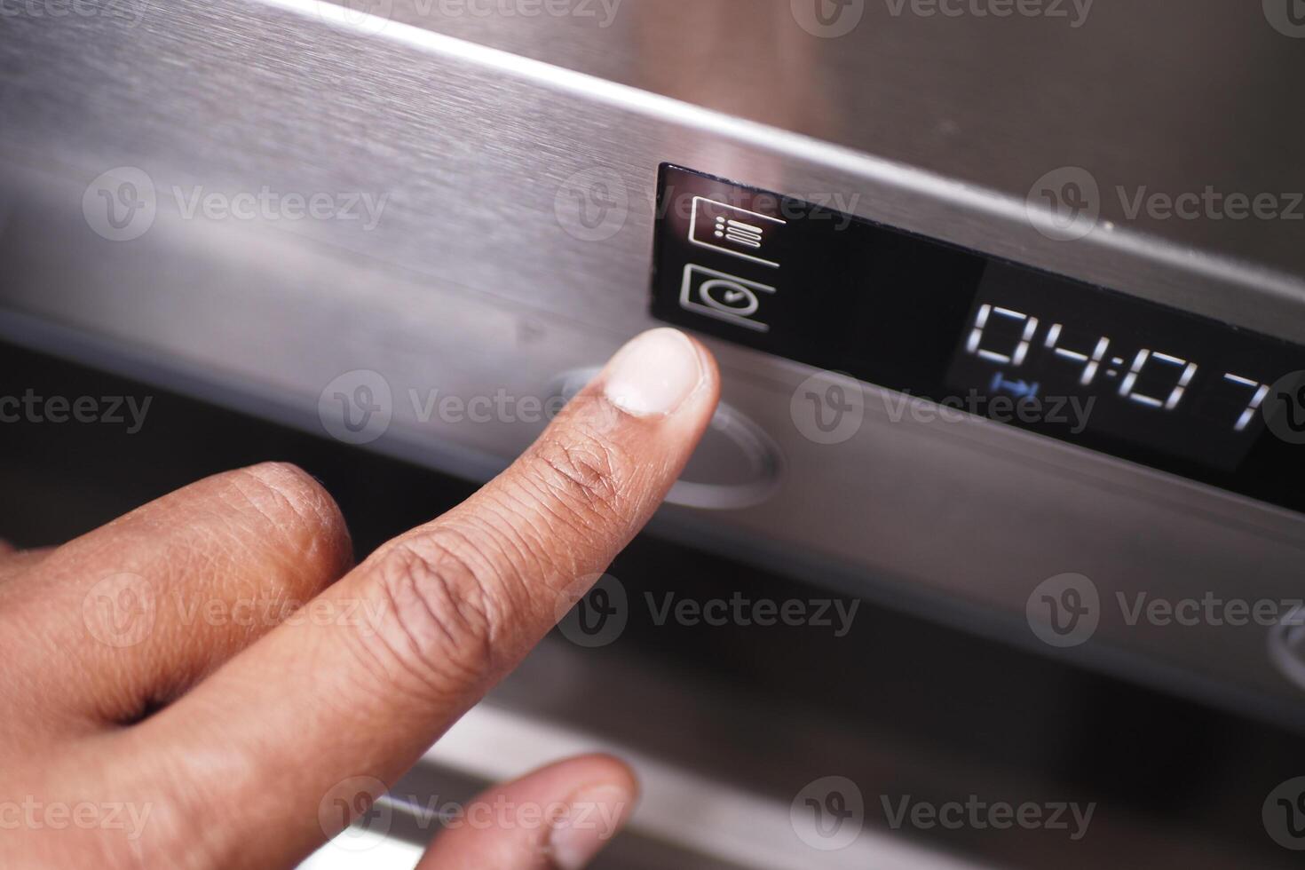 User Engaging with the Control Panel of a Microwave Oven for Cooking Convenience and Precision photo