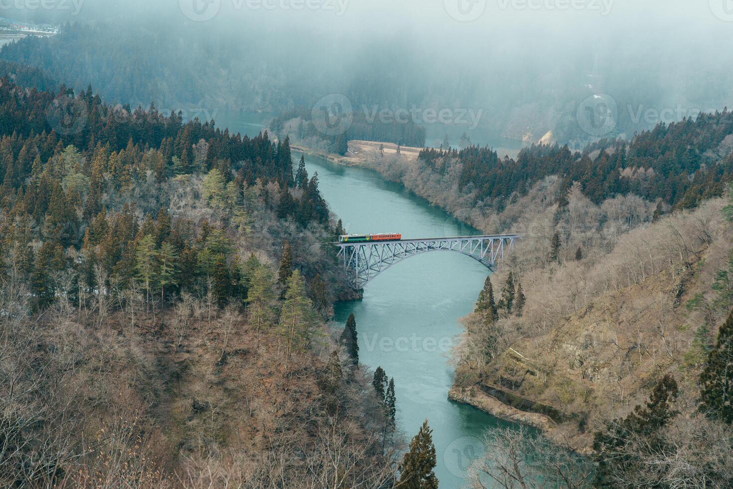 Panoramic View of Japan local train with Tadami river and bridge. Tadami Railway Line in The Valley at Mishima Machi, Aizu, Fukushima Prefecture, Japan. Landmark and iconic spot for tourist attraction photo