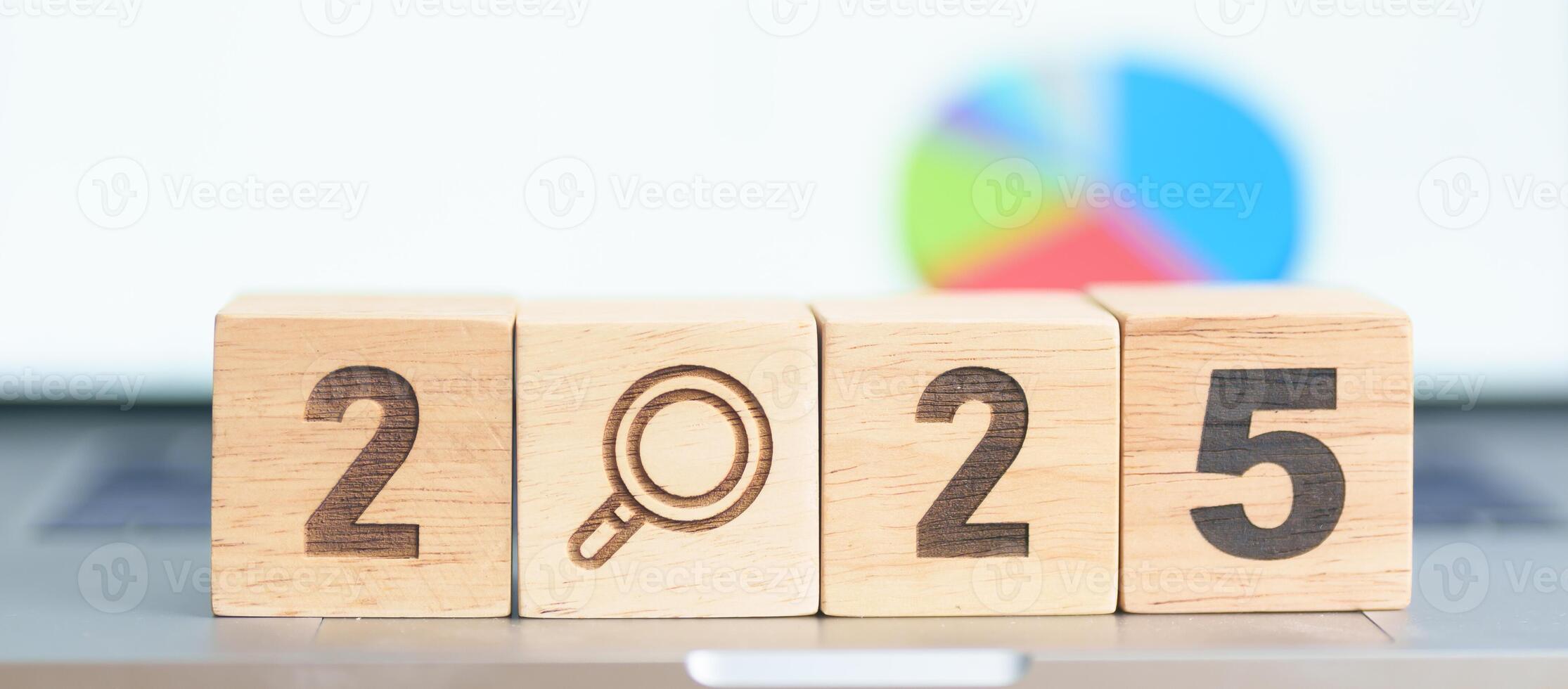 2025 Year block with magnifying glass icon against laptop computer. SEO, Search Engine Optimization, hiring , Advertising, Idea, Strategy, marketing, Keyword, Content and New Year start concepts photo