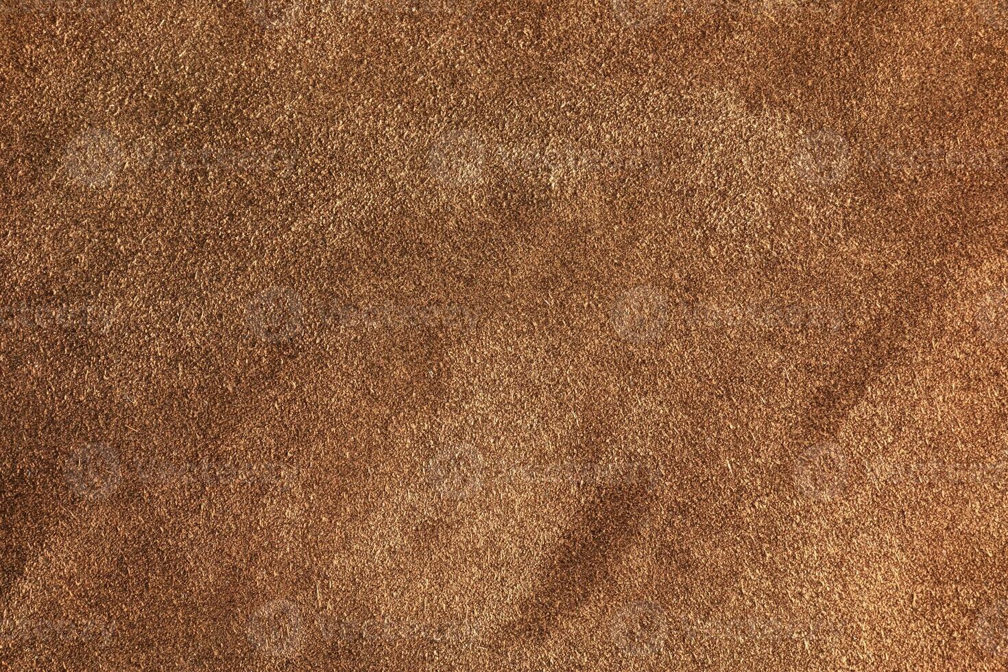 Brown suede closeup background. The texture of soft natural suede of the highest quality. photo