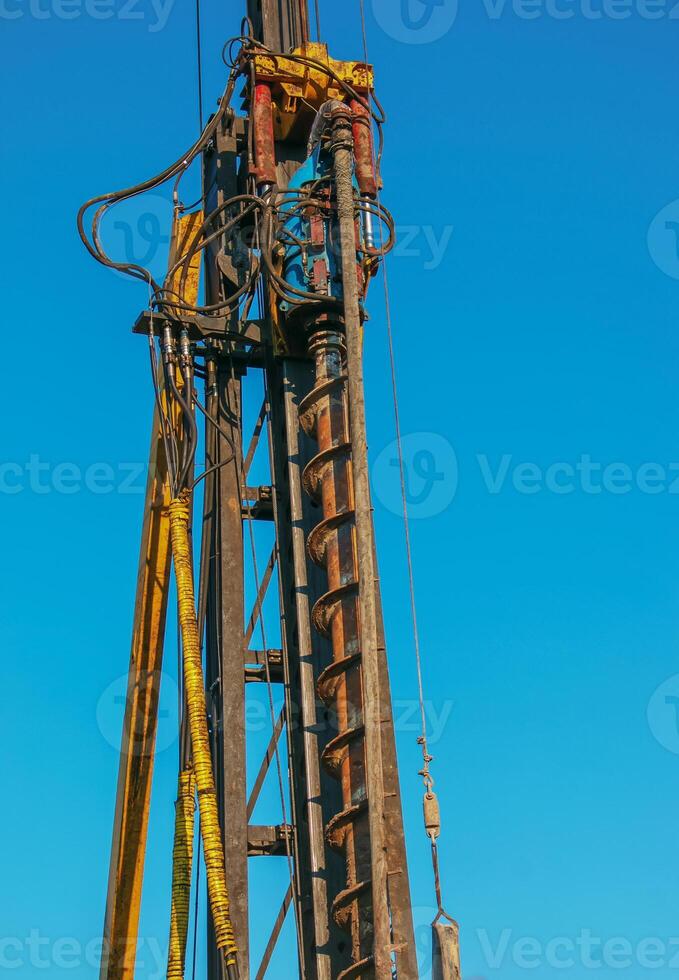 Hydraulic drilling rig. Installation of bored piles with a casing string. Foundations and grounds. Drilling in the ground. technology. Machine for drilling holes in the ground. photo