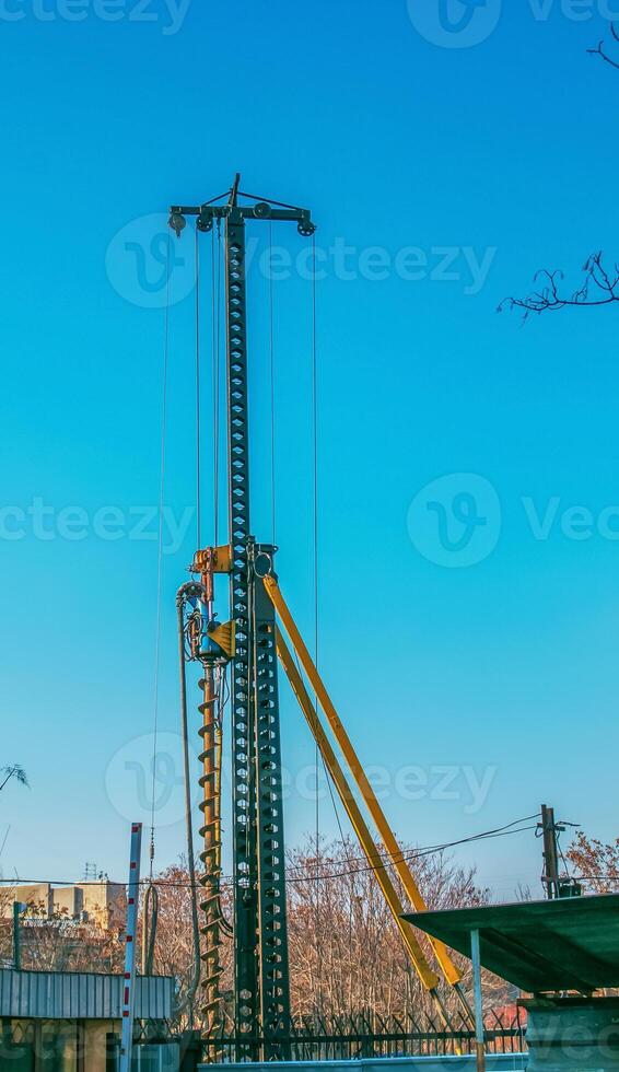 Hydraulic drilling rig. Installation of bored piles with a casing string. Foundations and grounds. Drilling in the ground. technology. Machine for drilling holes in the ground. photo