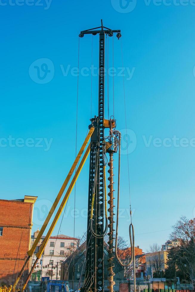 Hydraulic drilling rig. Installation of bored piles with a casing string. Foundations and grounds. Drilling in the ground. technology. Machine for drilling holes in the ground. photo