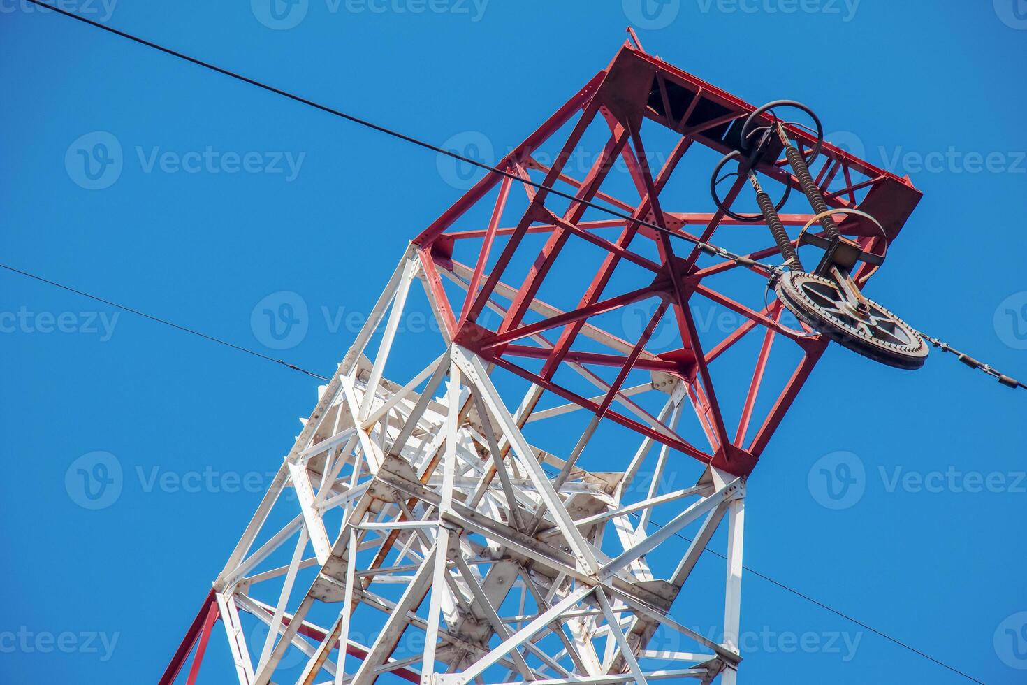 High voltage electric power lines on pylons in blue sky. photo