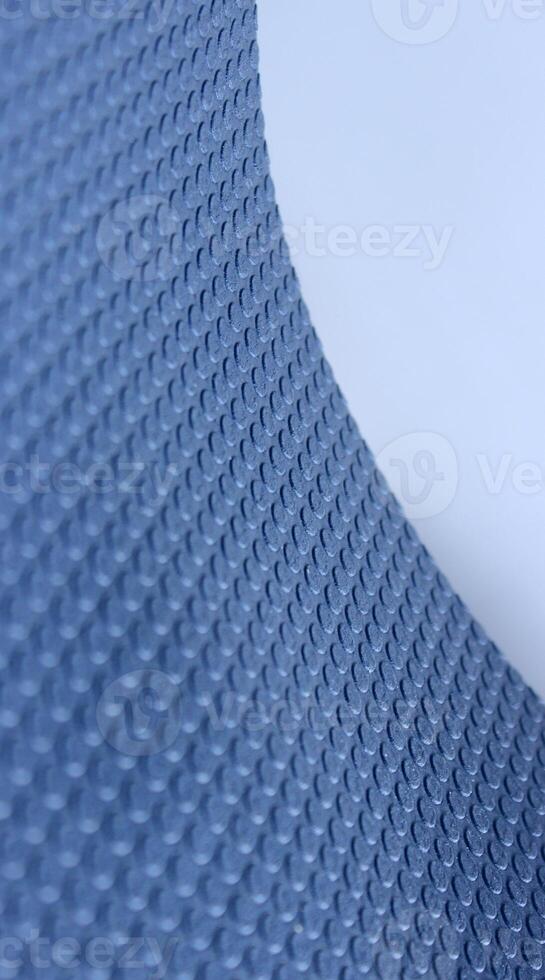 Curved Edge Of Sheet Of Elastic Material With 3D Extruded Circles On It. Stock Photo For Abstract Blue Backgrounds