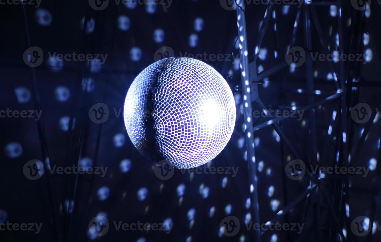Discotheque mirror ball with pin spots and haze bottom view photo
