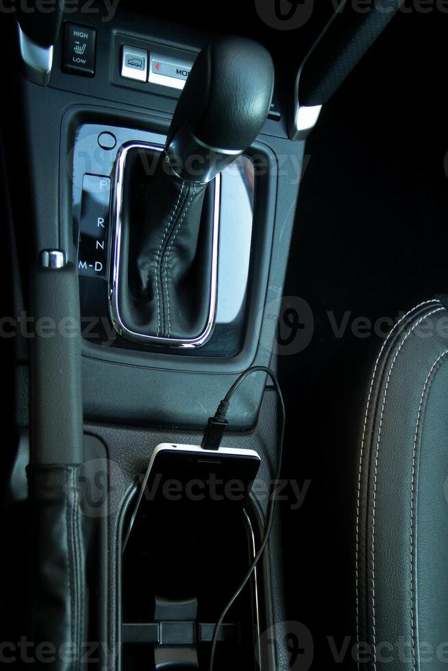 Mobile phone connected to car onboard network with charging function photo