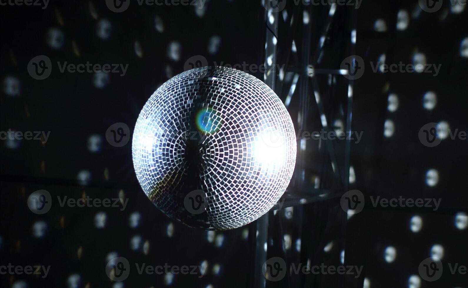 Mirror ball in ray of light by spotlight stock image photo