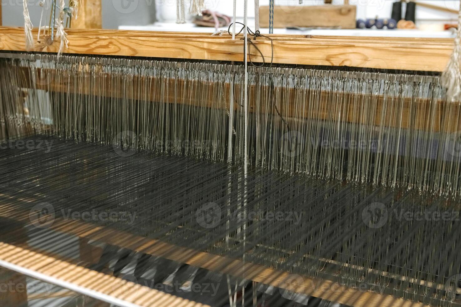 Traditional textile weaving loom in artisan workshop photo