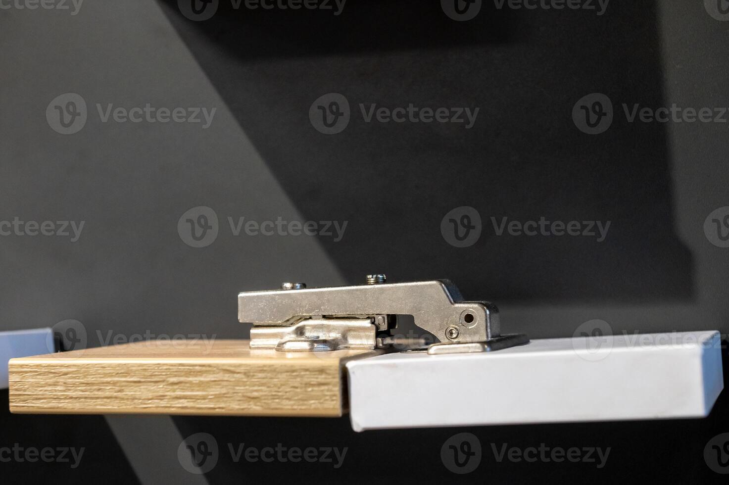 Modern Cabinet Hinge on Wooden Board photo