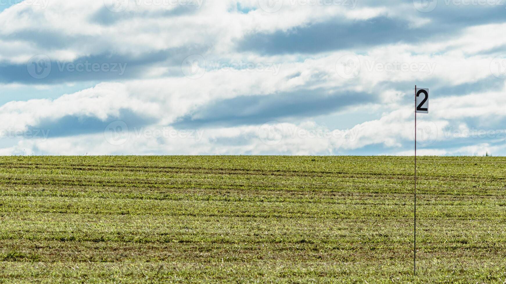 Golf course countryside field with flag and clear sky photo