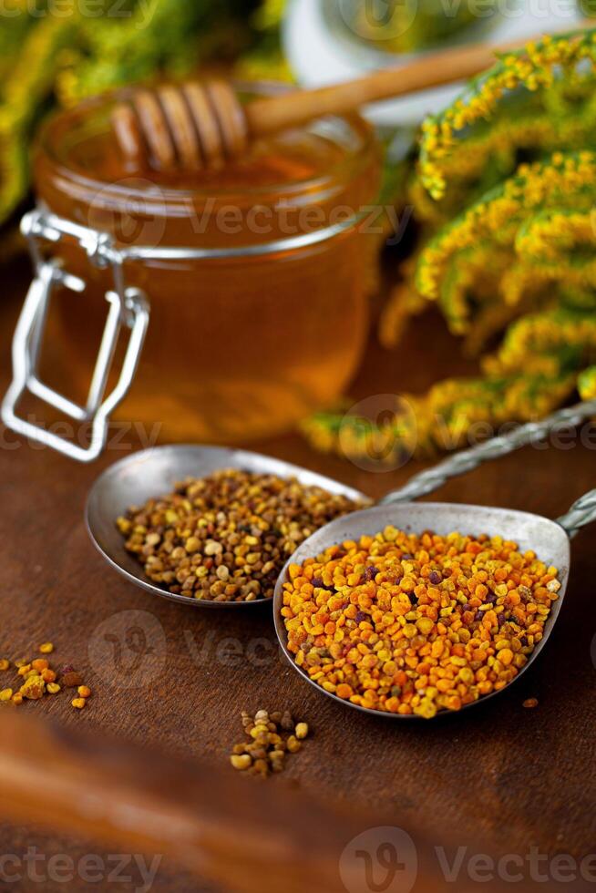 Honey in a jar. Bee pollen. Beekeeping product. Food on the table. Still life of flowers. photo