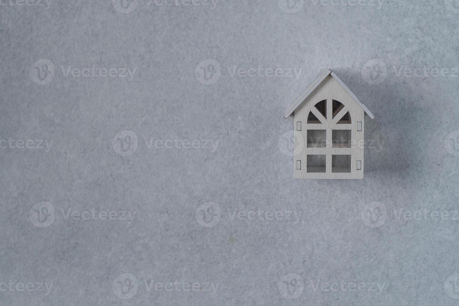 Wooden toy house. Gray copy space background photo