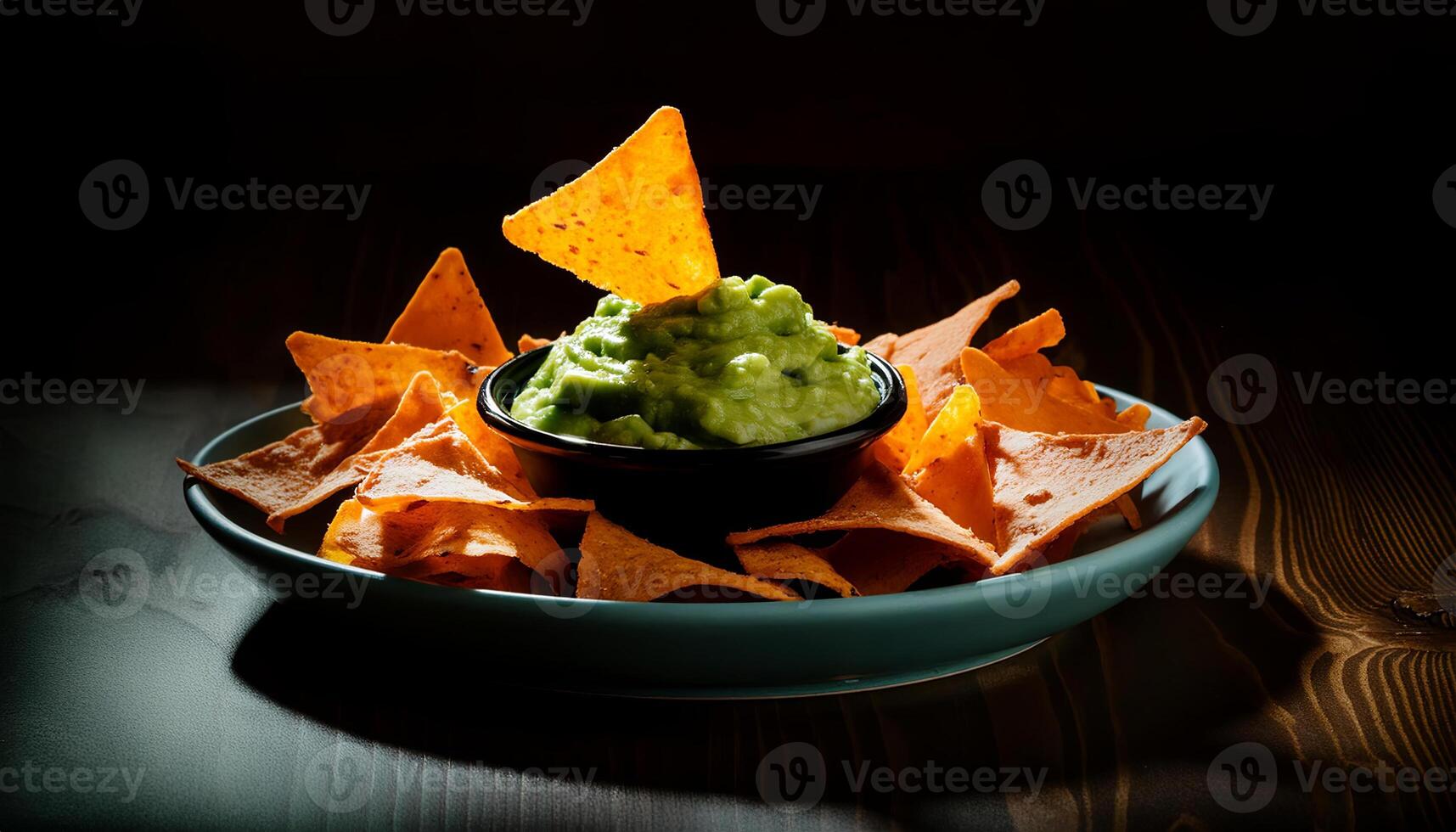 A bowl of chips and guacamole on a table photo