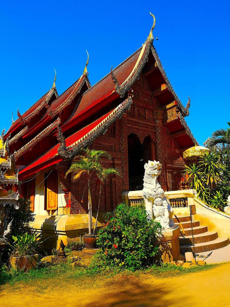 Buddhist Temple with a red roof in midday sun, Old City, Chiang Mai, Thailand, 2024 photo