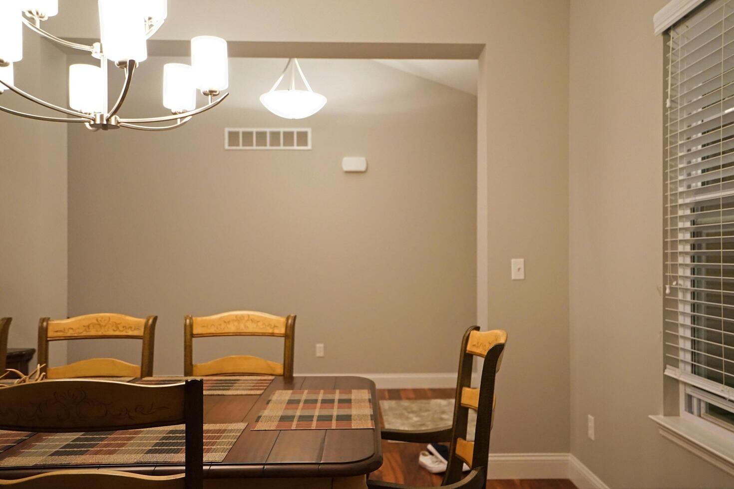 Interior American design and decoration of dining room decorated with wooden furniture and hanging chandelier photo