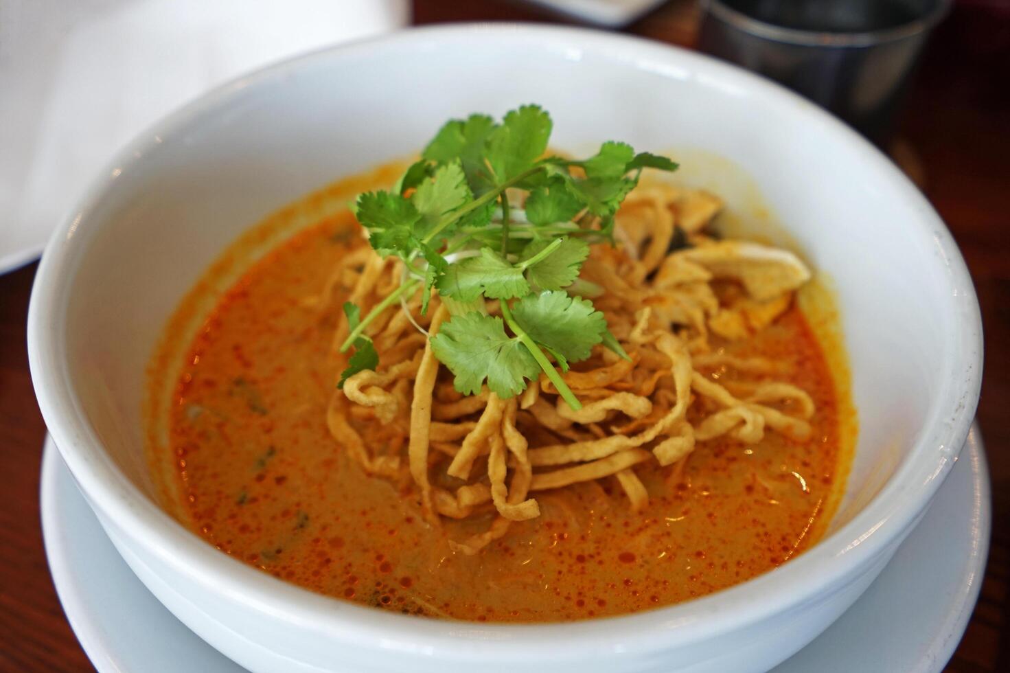 Close up Kao Soi, Northern Thai style egg noodles in coconut soup photo