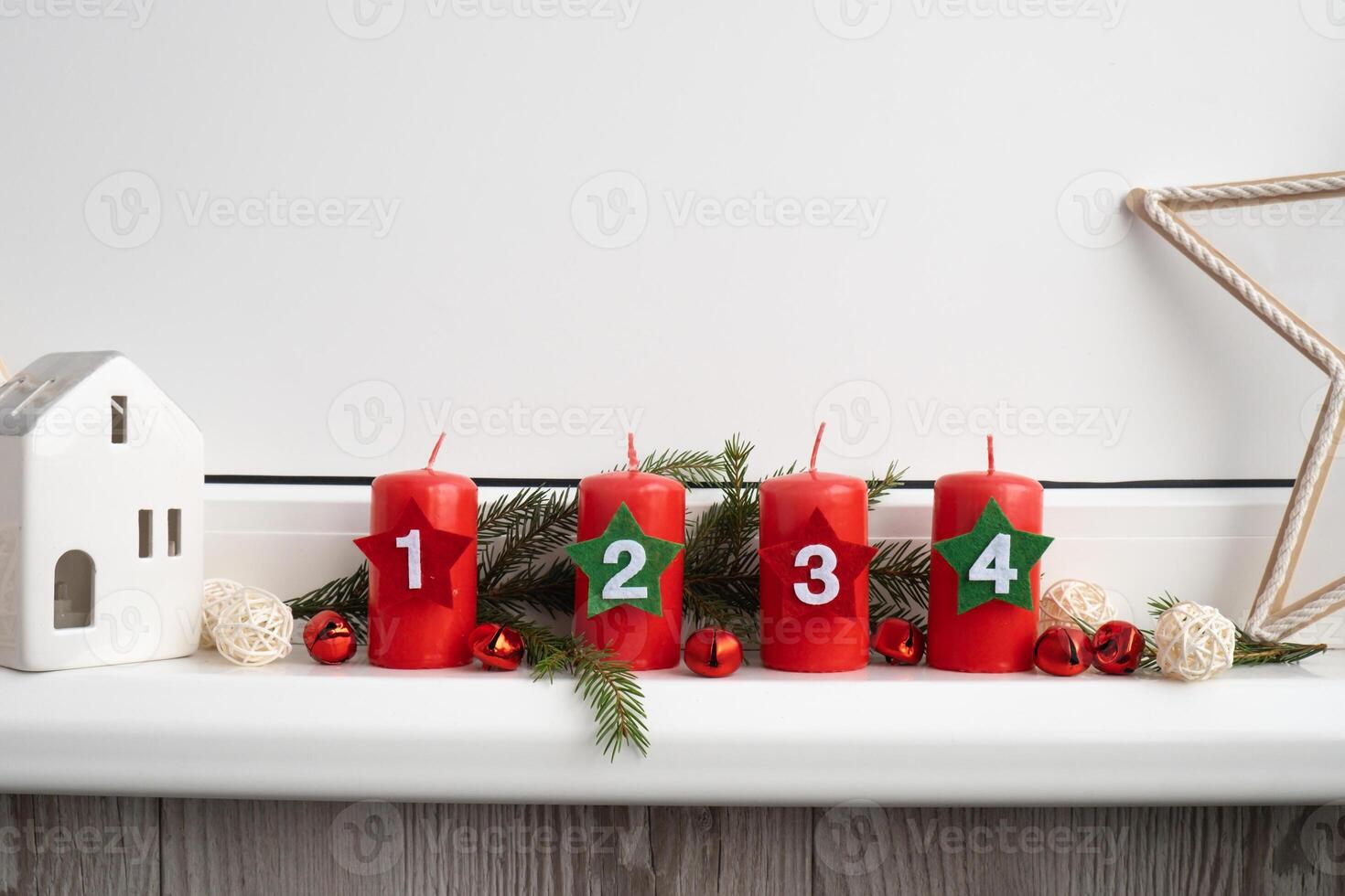 Traditional four advent weeks before Christmas holidays. Red candles with numbers and plastic free decoration. Copy space greeting card mock up template. Winter cozy home time photo