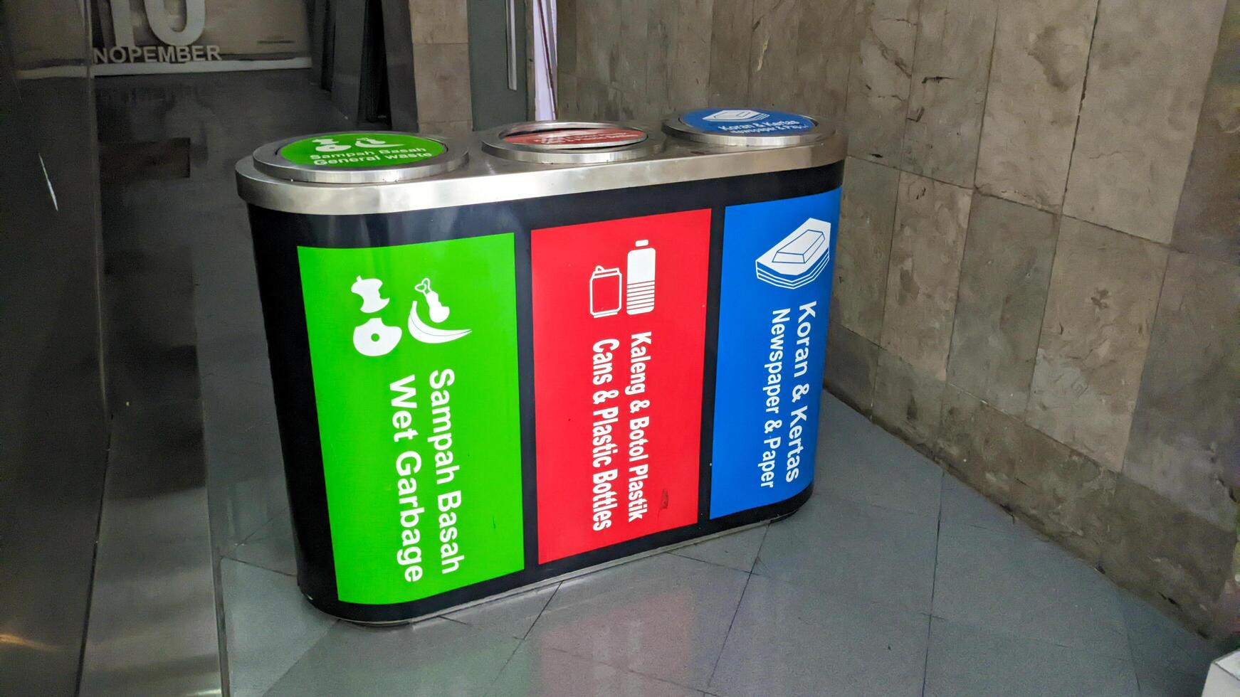 a trash can with three categories of trash. wet, plastic and paper waste photo