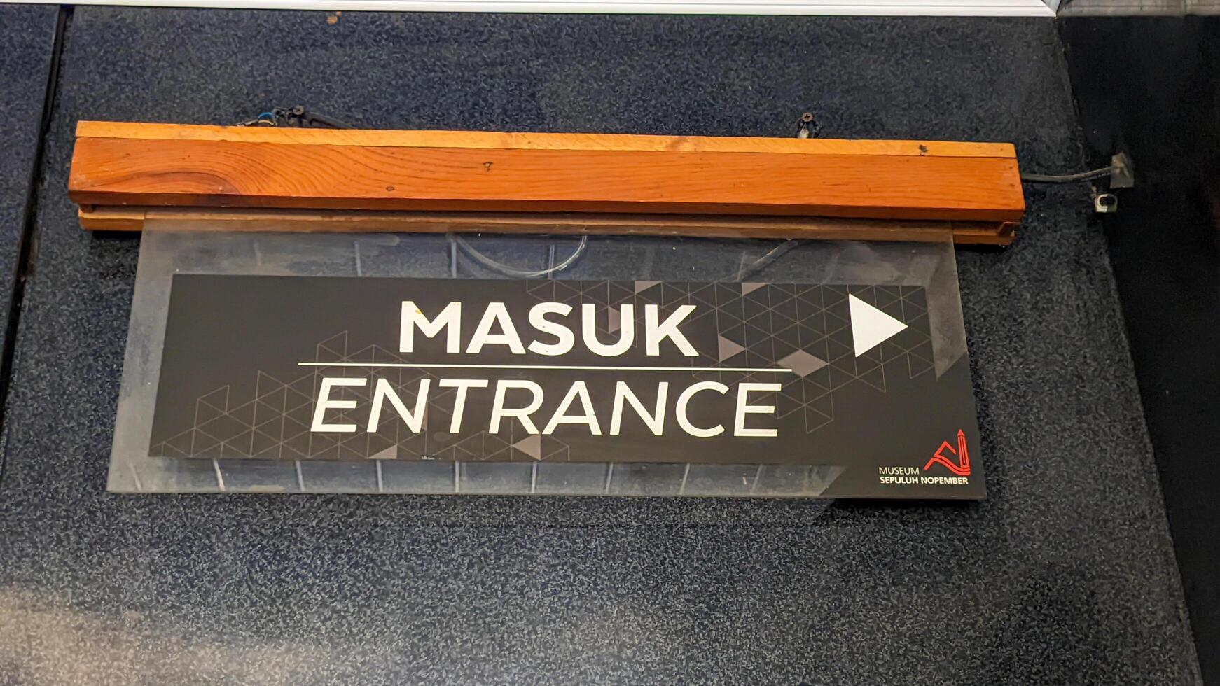 a signboard with the word entrance. Surabaya, indonesia - may, 2023 photo