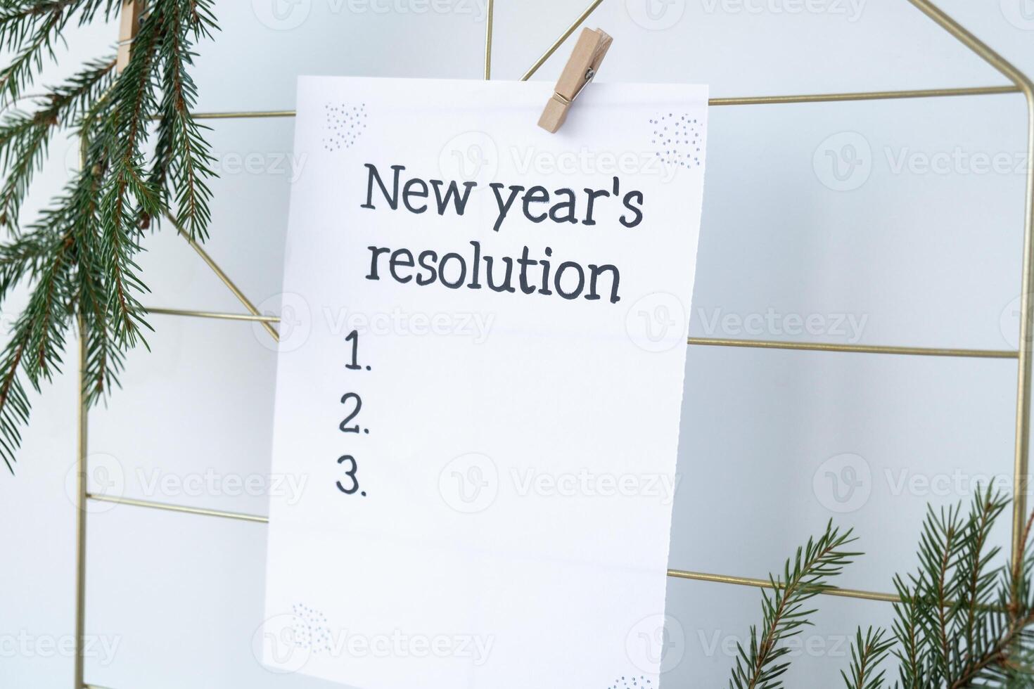 Vision board with NEW YEAR'S RESOLUTION aims goals on paper note. Preparation for New Year. Concept of planning and setting goals for personal development photo