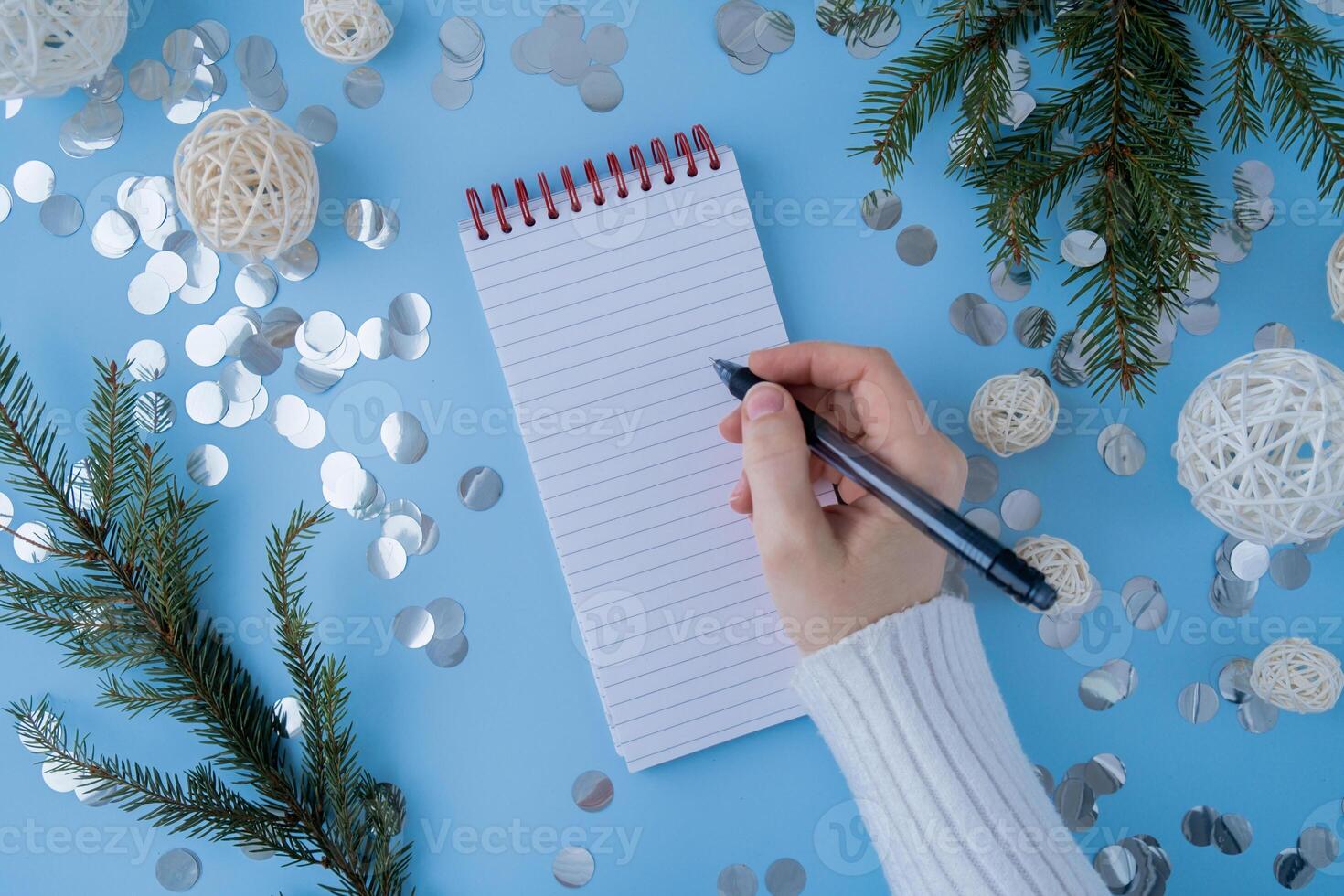 Woman writing letter to SANTA or promises and aims. Empty notebook Preparation for new year. Visualizing wish list for 2025. Dreams plan action resolutions for coming year. Inspirational self improvement concept photo