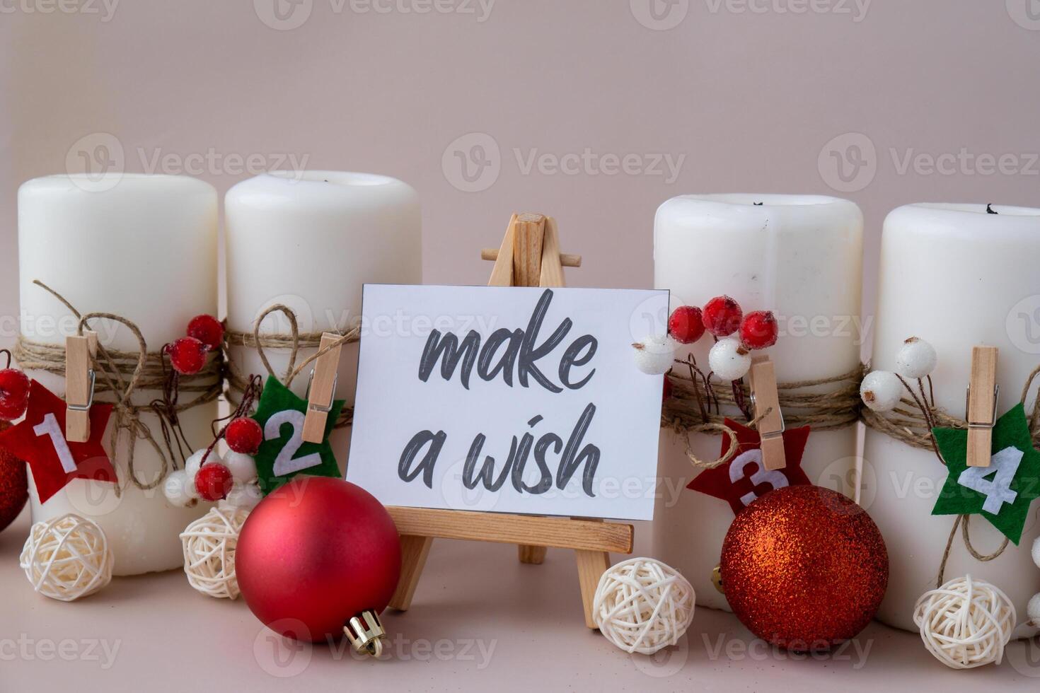 MAKE A WISH text on paper note Traditional four advent weeks calendar before Christmas holidays. Candles and plastic free zero waste sustainable decoration. Greeting card mock up template. Winter cozy home time photo