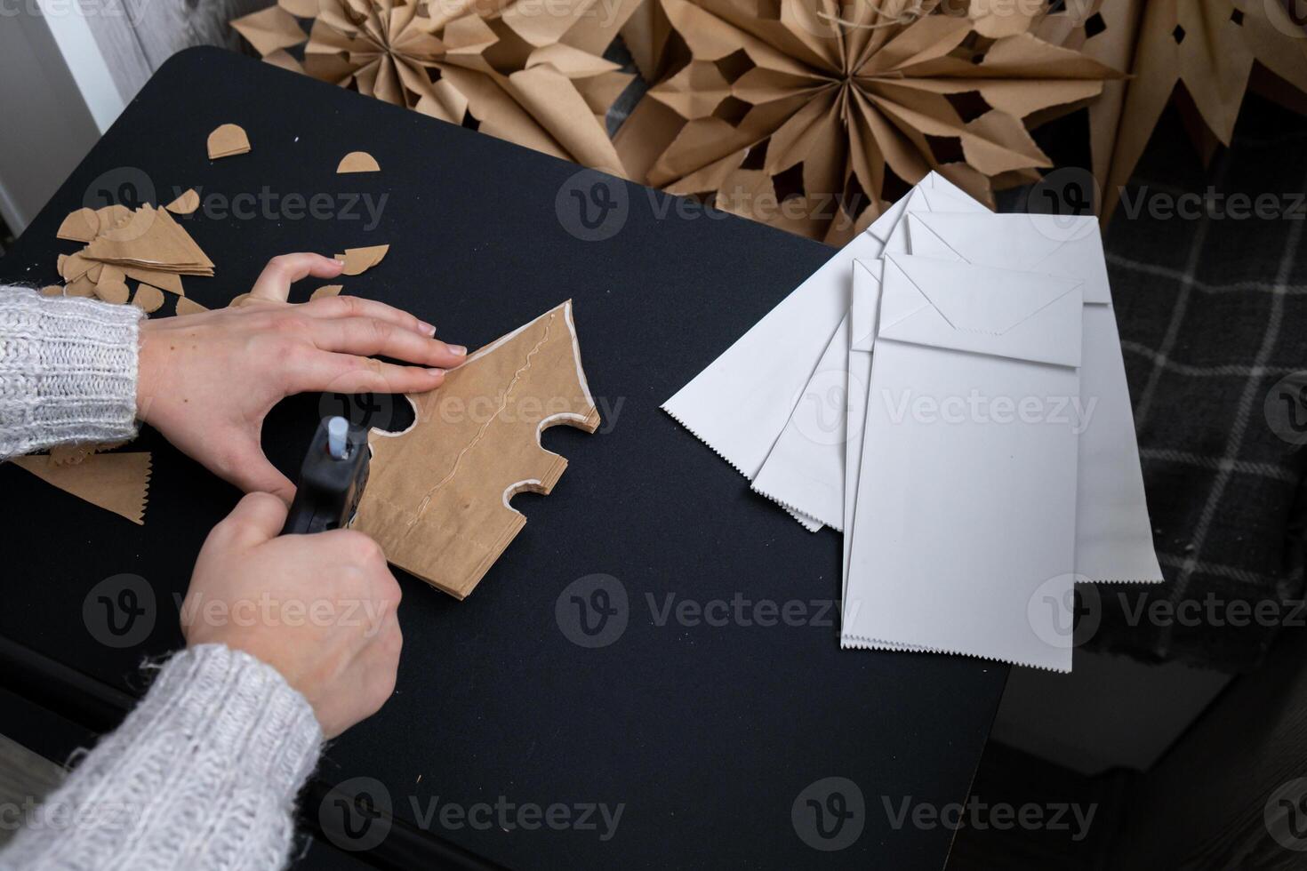 Sustainableminded Christmas cozy home handmade decoration. Tutorial for making do it yourself craft paper lunch bags and hot glue. Seasonal activity for kids. 3D snowflakes Christmas eve preparation photo