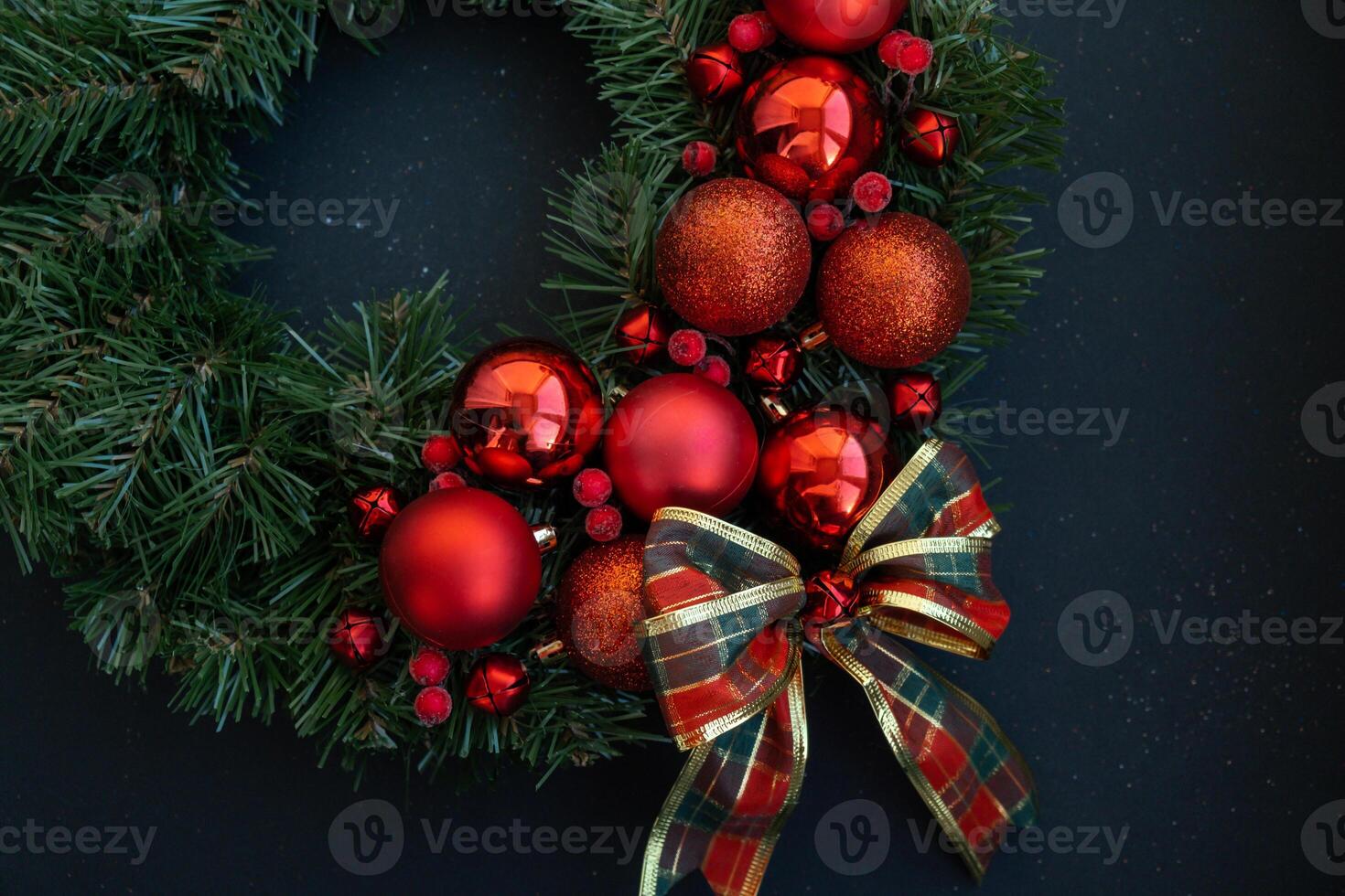 Handmade Christmas wreath from festive red decorations. Festive holiday preparation craft master class of creative making decor. Hands-on activities sustainable responsible holiday gift workshop creation. Top view, flat lay photo