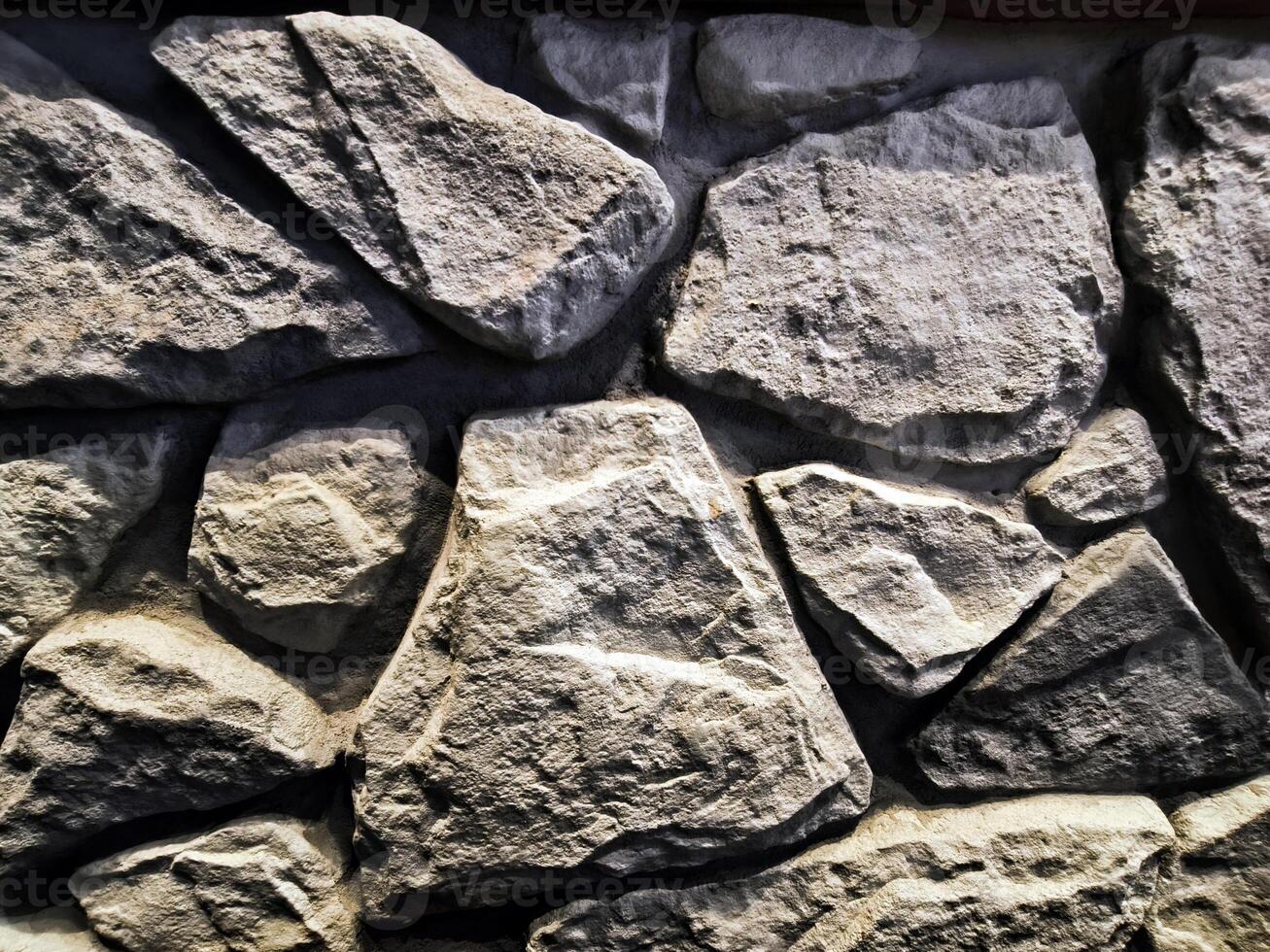Stone wall texture background and different sized stones modern loft design. photo