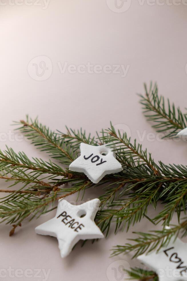 Christmas star with word PEACE JOY White air dry clay for making decor to Christmas tree holiday. Creating hobby recreation activity that involves fingers. DIY crafting Modern art photo
