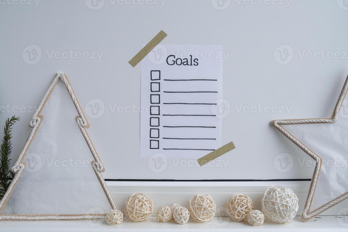 Paper note with inspirational to do checklist GOALS with natural zero waste homemade Christmas decor. Happy new year promises resolutions concept. Self growth and personal development photo